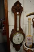 An oak cased barometer and thermometer (dial cracked).