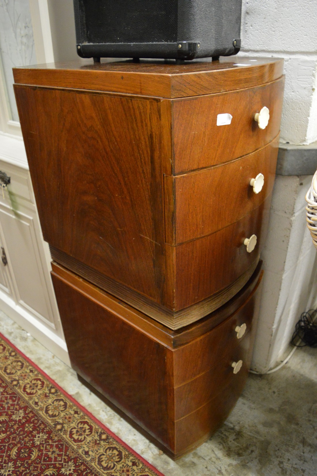 A pair of bow fronted bedside chests.