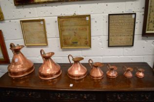 A graduated set of seven copper Haystack measures.