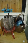 A small fruit press and a copper coal bucket.