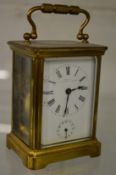 A brass carriage clock with alarm.