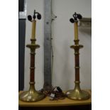 A large pair of brass and leather table lamps.