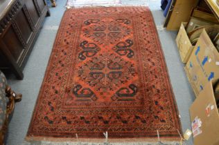 A Persian rug, red ground with stylised decoration 205cm x 130cm.