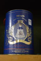 Bells whisky contained in a pottery bell shaped decanter with original box to commemorate the
