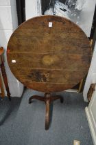 A 19th century oak circular tilt-top tripod table.