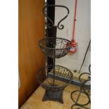 A wrought iron two tier fruit basket.