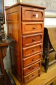 A Chinese red wood narrow seven drawer chest.