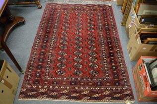 A Bokhara rug, red ground with three rows of thirteen gulls 180cm x 125cm.