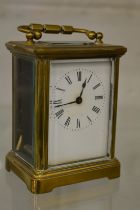 A brass carriage clock.