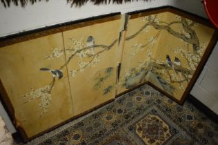 A Japanese painted four panel folding screen depicting birds among branches (faults).