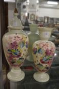 Two floral painted opaque glass vases, one with a cover.
