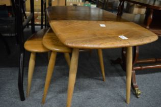 An Ercol light elm coffee table and two similar tables.