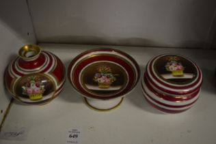 Three small pieces of Noritake porcelain decorated with baskets of flowers.