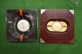 A Gucci perspex mounted clock and another similar.