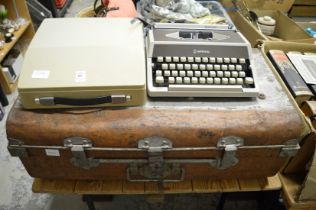 Portable typewriter and a tin trunk.