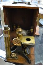 A mahogany cased brass microscope.