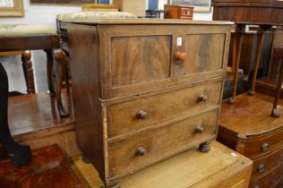 A 19th century mahogany commode with rising top and porcelain liner.