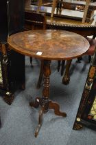 An inlaid walnut circular tripod table.