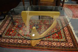 A 'Boomerang' glass top coffee table with folding support.