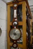 A mahogany cased barometer and thermometer.