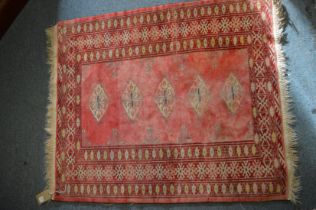 A small Tekke rug, pink ground with five central medallions 102cm x 86cm.