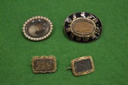 Four mourning brooches.