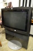 A large Bang & Olufsen TV on stand.