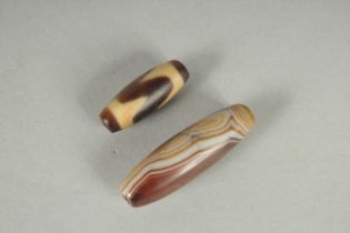 TWO TIBETAN AGATE DZI BEADS.