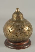 AN QAJAR OPENWORKED BRASS LIDDED MOSQUE LAMP, mountred to a wooden base.