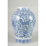 A LARGE CHINESE BLUE AND WHITE PORCELAIN VASE, painted with foo dogs and large flower heads with