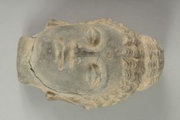A FINE GANDHARA CARVED GREY SCHIST BUDDHA HEAD, (cracked), 15cm high.
