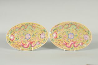 A PAIR OF CHINESE YELLOW GROUND FAMILLE ROSE PORCELAIN OVAL DISHES, painted with dragon and flora,
