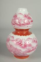 A CHINESE PINK AND WHITE PORCELAIN DOUBLE GOURD VASE, painted with sweeping landscape scenes, the