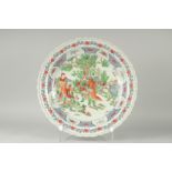 A LARGE CHINESE FAMILLE VERTE PORCELAIN CHARGER, painted with figures around a tree, 45cdm
