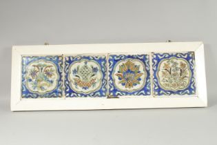 FOUR 17TH CENTURY KUBACHI GLAZED POTTERY TILES, each painted with central floral motif, inset