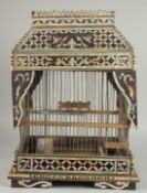 AN EARLY 20TH CENTURY MOTHER OF PEARL AND TORTOISESHELL INLAID BIRD CAGE, 49cm high. 252.
