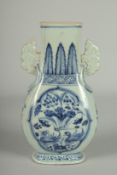 A CHINESE BLUE AND WHITE PORCELAIN TWIN HANDLE VASE, painted with panels of ducks and lotus, 20.