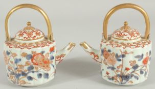 A FINE PAIR OF JAPANESE IMARI PORCELAIN TEAPOTS, painted in the typical Imari palette with blue, red