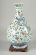 A CHINESE UNDERGLAZE RED, BLUE AND WHITE DRAGON AND PHOENIX YUHUCHUNPING VASE, on a fitted