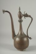 AN 18TH CENTURY PERSIAN SAFAVID COPPER EWER, the handle and spout with dragon head terminals, 38cm