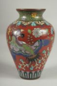 A CHINESE RED GROUND CLOISONNE PHOENIX VASE, with butterflies and various floral motifs, 12.5cm