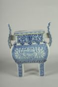 A CHINESE BLUE AND WHITE PORCELAIN TWIN HANDLE CENSER, raised on four square-form feet, 19.5cm