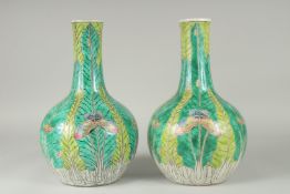 A PAIR OF CHINESE FAMILLE VERTE PORCELAIN BOTTLE VASES, painted with butterflies and leaves, 35cm