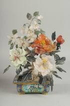 A CHINESE HARDSTONE BONSAI TREE IN A CLOISONNE PLANTER, the petals with carved jade and other