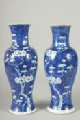 A PAIR OF CHINESE BLUE AND WHITE PORCELAIN PRUNUS BALUSTER VASES, 30cm high.
