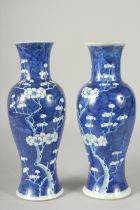 A PAIR OF CHINESE BLUE AND WHITE PORCELAIN PRUNUS BALUSTER VASES, 30cm high.