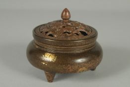 A CHINESE BRONZE GOLD SPLASH CENSER AND OPENWORK COVER, on tripod legs with character mark to