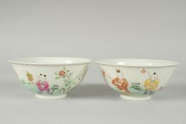 A PAIR OF EARLY 20TH CENTURY FAMILLE ROSE PORCELAIN RICE BOWLS, painted with boys, each with red