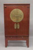 A LATE 19TH - EARLY 20TH CENTURY CHINESE RED LACQUER MARRIAGE CABINET, with a pair of brass