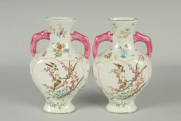 A PAIR OF CHINESE FAMILLE ROSE PORCELAIN TWIN HANDLE VASES, painted with birds and flora, each